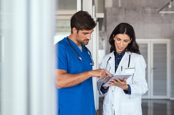 Doctor-and-nurse-discussing-report-1189303565_6880x4584