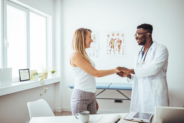 male-african-adult-doctor-consultation-room-holding-patint-hand-web